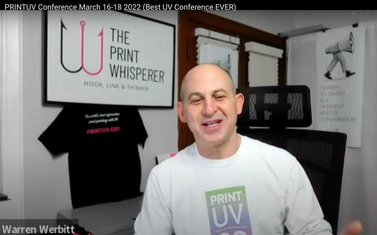Warren Werbitt smiling in his studio beneath a The Print Whisperer sign in a video frame